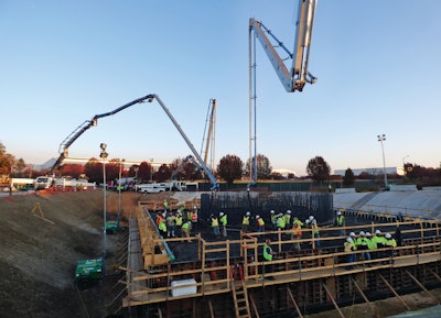 Three Putzmeister pumps – two 56Z-meters and a 58-meter – continuously placed concrete for the control tower base, as mixer trucks discharged two at a time into each hopper.