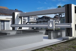 Rendering of Vulcan II 3D printer printing a 'Lavacrete' home.