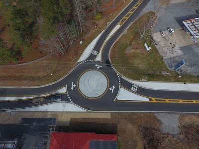 Piedmont Paving waited a state-mandated 14-day period following paving before installing thermoplastic markings. Once the thermoplastic is down they returned and addressed the shoulders and finished any grassing and grading work.
