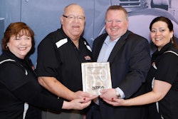 Accepting the award for Flaps Up from NTEA President & CEO Steve Carey (second from right) are, from left to right: Maureen Earp Wood, Jerry Proctor and Judy M. Turner.