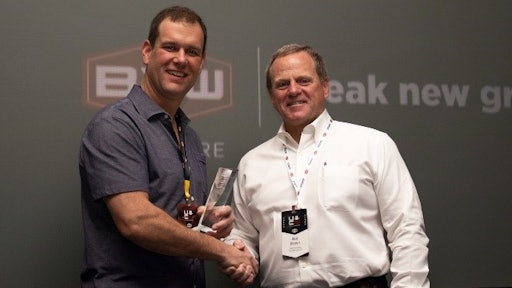 Bob Brown, right, president of B2W Software presents the B2W Software 2019 Client Innovation Award for Best Use of the B2W ONE Platform to Ryan Priestly, president of Priestly Demolition.