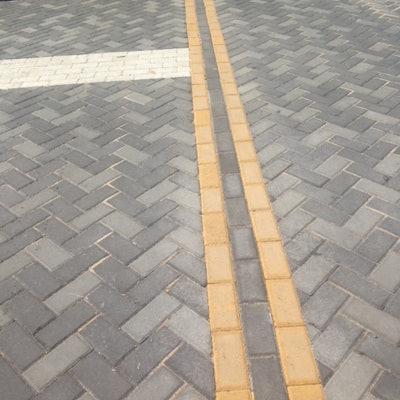 CityStone pavers were customized in yellow and white to create driving and biking lanes and parking stripes.