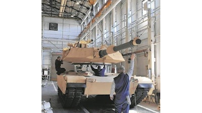 The $5.2 million for Anniston Army Depot (mechanics shown working in Anniston on an M1 Abrams tank) to build a weapons maintenance shop that was due to be awarded in March 2020 could be cut to fund Trump's border wall.