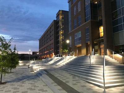A combination of light, medium and dark gray 12-ft-by-12-ft Holland pavers from Pavestone were installed to give the four plazas a modern look.