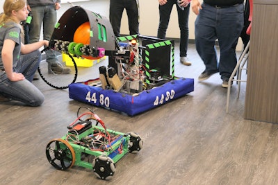 UC-Botics team member and the team’s robots.