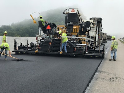 99% of the mix was placed with a Caterpillar AP1055F paver with the specialized high density screed and most of the rolling was done with Caterpillar CB54 XW rollers. The intermediate and surface mixes were installed with the use of a Roadtec SB-2500 Shuttle Buggy to prevent segregation. The company also rented a Vögele Super 700-3i paver to pave the 4-ft. shoulders on the project.