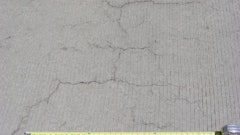 Occurring in both random and parallel patterns, plastic shrinkage cracks are discontinuous, relatively short and typically fairly shallow. Occasionally they can become full-depth cracks. Parallel cracks are typically spaced between a few inches to several feet apart and many times are oriented perpendicular to the prevailing wind direction. Cracks widths at the surface can be fairly wide (as much as 1/8 in.) but rapidly diminish with depth.