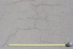 Occurring in both random and parallel patterns, plastic shrinkage cracks are discontinuous, relatively short and typically fairly shallow. Occasionally they can become full-depth cracks. Parallel cracks are typically spaced between a few inches to several feet apart and many times are oriented perpendicular to the prevailing wind direction. Cracks widths at the surface can be fairly wide (as much as 1/8 in.) but rapidly diminish with depth.