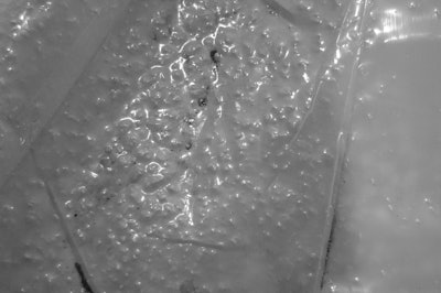 Because the contractor placed concrete from the back of ready-mix trucks, they didn’t select a vapor barrier with enough puncture resistance to remain intact under the wheels of the trucks.