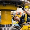Komatsu employee at the Peoria, Ill., plant inspects an electric dump truck component. Komatsu has 28 U.S. manufacturing facilities that produce construction, mining, forklift and forestry equipment.