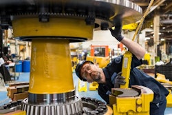 Komatsu employee at the Peoria, Ill., plant inspects an electric dump truck component. Komatsu has 28 U.S. manufacturing facilities that produce construction, mining, forklift and forestry equipment.