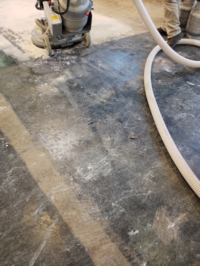 Once all floor coverings, adhesives and epoxies were removed, minor repairs were made, and the floor was ready for multi-step grinding.