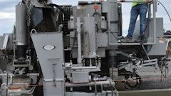 Owner Travis Knox places a section of curb. Only himself and another crew member are trained to operate the curb and gutter machine.