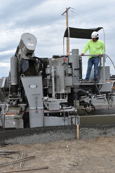 Owner Travis Knox places a section of curb. Only himself and another crew member are trained to operate the curb and gutter machine.