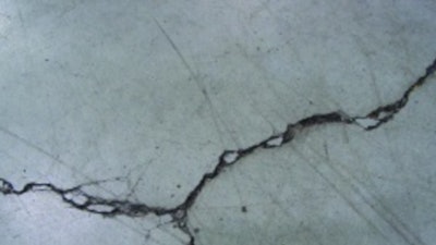 Unrestricted crack width growth leads to spalled edges along out-of-joint cracks when exposed to wheeled traffic.