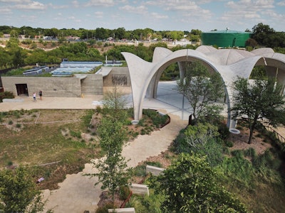 Winding paver walkways mimic the flow of water from the surrounding rivers, native plants frame paver walkways, while paver branches lead to the 29-foot concrete petals that form into pavilions.