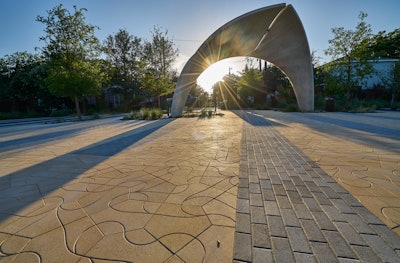 Surface indents in the custom pentagonal pavers are meant to imitate meandering rivers and streams.