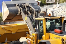 A Volvo autonomous L120 wheel loader and A25F articulated hauler carry out a loading and transport operation.