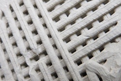 Prototype samples of 3D-printed concrete. The cube is about 1 square inch in volume.