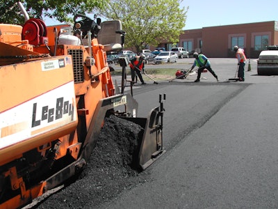 If the proper amount of mix is placed in the proper place, no raking of the mix at the longitudinal joint is necessary.