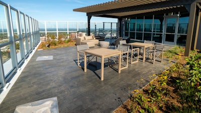 SUNDEK's system mix is an architectural limestone coating with limestone aggregates, and the hardened finish looks and feels like actual stone.