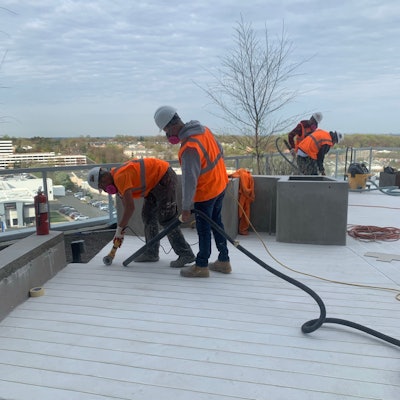 After the application of the overlay, workers laid out the pattern and cut it into the overlay with a diamond bit on an angle grinder.