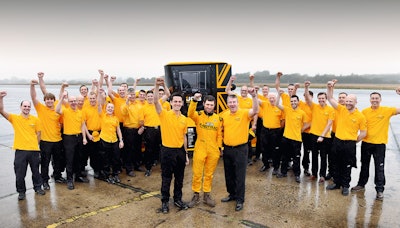 The team celebrates landing the World's Fastest Tractor record. In the foreground are l-r Alex Skittery, Guy Martin and JCB Chief Innovation and Growth Officer Tim Burnhope.