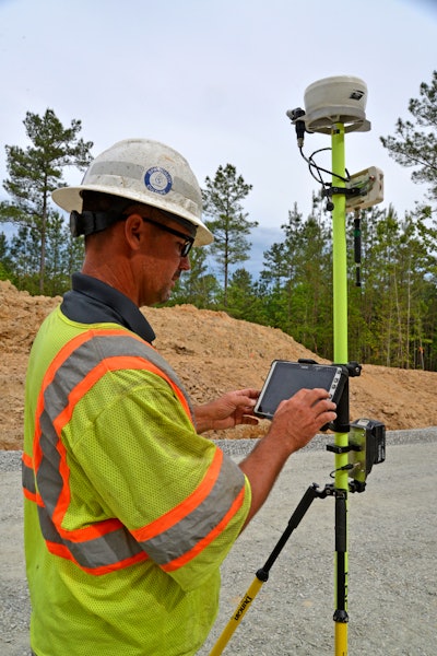 Clay Armstrong of Talley & Armstrong, Inc. confirms data points on the Wirtgen AutoPilot 2.0 portable tablet attached to the Field Rover survey pole.