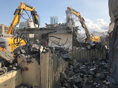 Because of the structural configuration of the building, with its cross-shaped long beams spanning each of the four wings, CDI opted for a diagonal implosion pattern, which took the building down on an angle to the southeast.