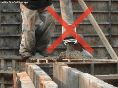 A double-ended concrete delivery hose improperly being used as an end hose.