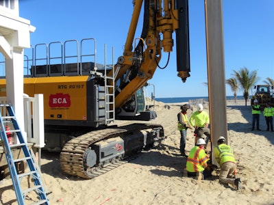 The RG 19 T vibrated each 4-ft. 9-in.-wide interlocked sheet pile into the beach, displacing 12,000 tons of sand in the process.