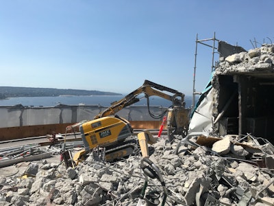 Systematically crushing concrete and cutting reinforcement steel, the Brokk operators directed the remote-controlled machines to work their way through the gutted tower of the Empire Landmark Hotel, taking advantage of the Brokk robots’ extended range of motion.