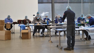 Genie team members making face coverings.