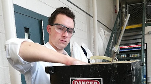 Auburn junior Philip McMichael prepares to filter wood fibers for cellulose extraction.