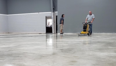 Pastor Josh Moore assists Roy Mathis of GranQuartz polishing the Ameripolish Smartfloor process.