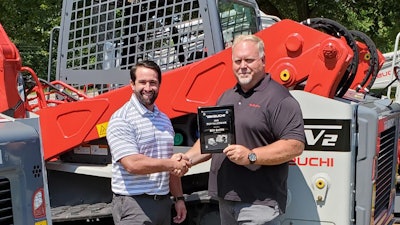 Mr. Bill Smith receiving the Top Salesman of the Year Award for the third time.