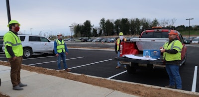 Schlouch crews practice social distancing during safety huddles. Huddles act as a reset button each day to review potential jobsite hazards and COVID-19 prevention information.