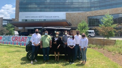 A team from KIOTI Tractor visited UNC REX Healthcare in Raleigh, North Carolina, to donate 10,000 N-95 masks as well as a K9 2440 utility vehicle. Pictured from left to right: Anna Dixon, KIOTI Tractor Daedong-USA Inc.; Peter Kim, president and CEO, KIOTI Tractor Daedong-USA Inc.; Sylvia Hackett, vice president, REX Healthcare Foundation; Andrew Zukowski, CFO, UNC REX Healthcare; Anna Kim, COO, KIOTI Tractor Daedong-USA Inc.; Wade Barnes, KIOTI Tractor Daedong-USA Inc.; and Nicole Longmire, KIOTI Tractor Daedong-USA Inc.