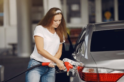 Focused Young Woman Refueling Car 4173094