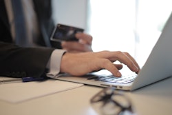Person In Black Suit Typing On A Computer 3760081
