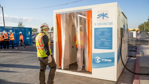 SR Construction employees walk through the Xtreme Opti-Clean Cube.