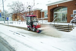 Ventrac 4500 removing snow with a power broom.