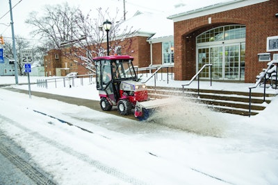 Ventrac 4500 removing snow with a power broom.