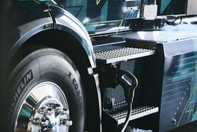 The CCS2 connector and charging port location on the Volvo VNR Electric truck model.