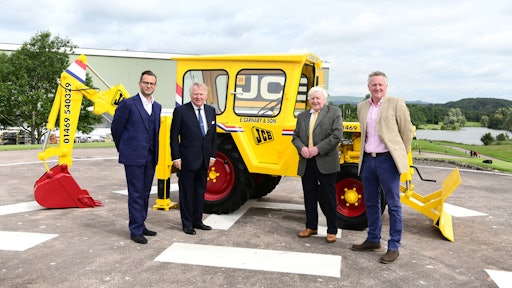 Shown with the restored 1964 JCB 1 backhoe (from left to right): George Bamford, Sir Anthony Bamford, Roland Carnaby Sr. and Roland Carnaby Jr.