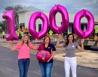 Amy Miller (L) and Natasha Ozybko (R) surprising WofA’s 1,000th member Marsha Johnson (C) at her jobsite.