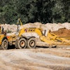 Summit utilized two Volvo 40-ton articulated dump trucks pulling K-Tec 1237ADT scrapers (such as shown) in a train configuration on the long haul from the east spoil pile.