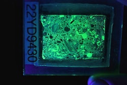 Figure 2. Photograph of a fluorescent thin section in UV light, which makes the concrete glow.