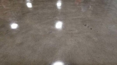 The concrete pictured here is a 1,500 grit polished finish densified with lithium silicate. Once the densifier was dry the coating was sprayed over the surface just enough to ‘wet out’ the surface. The surface was dry to touch in 4 hours and forklift ready in 12 hours the next day.