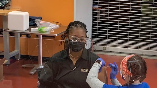 CB ISO Compliance Technician, Evelyn Ruff, receives her first Pfizer vaccination from Coastal Care Partners at JCB’s onsite vaccine clinic.